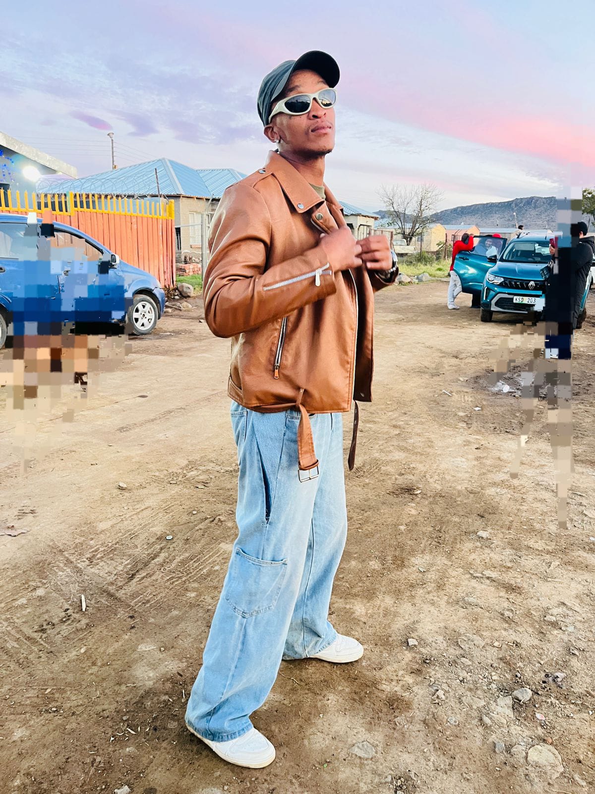 YungSavage QTN standing on a township street at golden hour in Queenstown